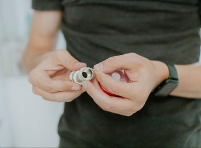 Plumber wrapping PTFE tape on threaded pipe fitting